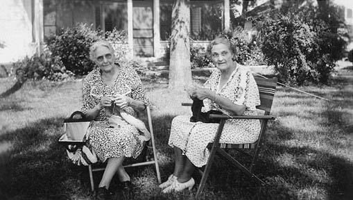 Eunice and Ria knitting in the front yard of the big house
